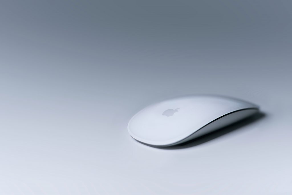 Image of a Magic Mouse from Apple. Apple uses design thinking processes to improve their products for customers.